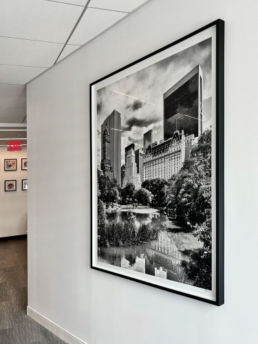 A 60x48 inch framed black and white photo of Central Park Pond and Plaza Hotel by fine art photographer Andrew Prokos installed in the offices of a financial services company in Manhattan, NYC