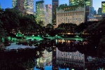 A high-definition fine art photo of the skyscrapers along Fifth Avenue, the Plaza Hotel, and the Pond in Central Park at dusk