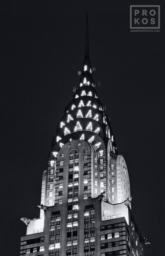 A black and white fine art architectural photo of the illuminated spire of the Chrysler Building at night