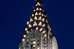 A photograph of the Chrysler Building's illuminated spire at night, New York City.