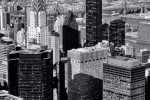A black and white cityscape photo of Midtown Manhattan and the spire of the Chrysler Building from the top of the Empire State Building, New York City