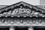 A detail from the pediment of the US Department of Commerce building in black and white, Washington DC