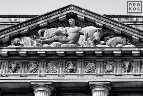 A black and white architectural detail photo of the pediment from the US Department of Commerce building in black and white, Washington DC
