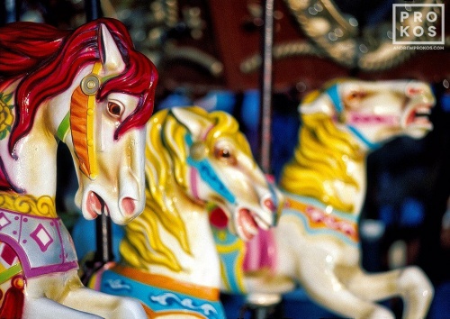 A fine art photo of the the colorful horses from the carousel at Coney Island in Brooklyn, New York