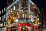 A street scene showing the Crown and Anchor pub and patrons at night, London, United Kingdom. Large-format limited edition prints of this photo are available up to 80 inches in height