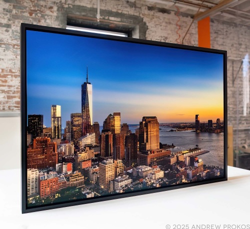 A framed photo of the World Trade Center and Downtown Manhattan at dusk by photographer Andrew Prokos