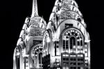 A black and white photograph of the spires of Dubai's al-Kazim towers at night. High-definition fine art prints of this photo are available up to 80 inches in height.