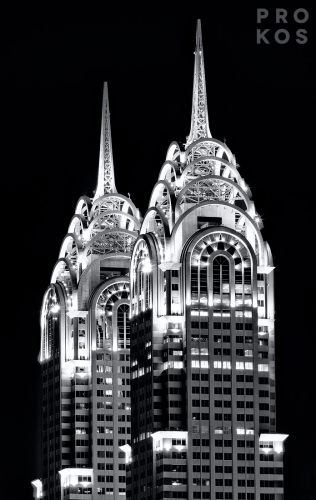 A black and white photograph of the spires of Dubai's al-Kazim towers at night. High-definition fine art prints of this photo are available up to 80 inches in height.