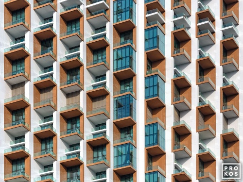 A fine art architectural photo of colorful tiered balconies from a contemporary architectural facade in Dubai, United Arab Emirates. Framed fine art prints of this photo are available up to 80 inches in width