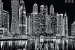 A black and white large format photograph of a view of the tall towers of Dubai Marina at night by photographer Andrew Prokos