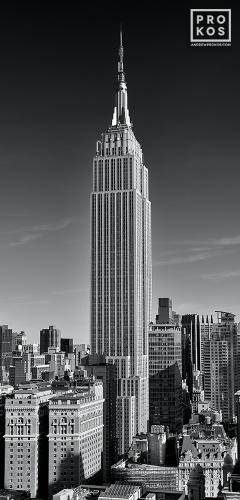 A black and white vertical panoramic view of the Empire State Building and Midtown Manhattan, New York City. High-definition fine art prints of this photo are available up to 90 inches in height and framed in wood, metal, and acrylic styles.