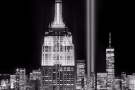 A black and white view of the Empire State Building, World Trade Center and New York City skyline at night captured on the 20th anniversary of September 11th. Large-format limited edition prints of this photo are available up to 80 inches in height and framed in various styles. 