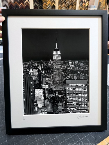 View of the Empire State Building from Rockefeller Center at Night - Black & White Matted and Framed Photo by Andrew Prokos