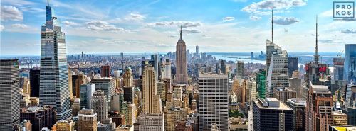 A high-definition panoramic skyline of the skyscrapers of Midtown Manhattan NYC and the Empire State Building as seen from from Rockefeller Center by photographer Andrew Prokos