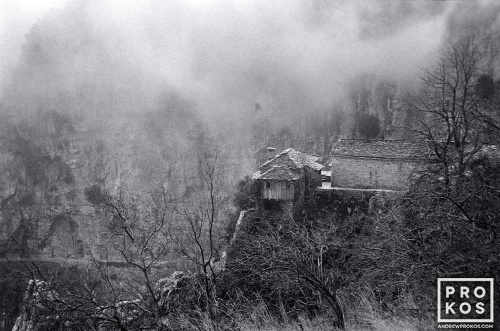 A black and white landscape photo of the Agia Paraskevi monastery in Vikos Gorge, Epirus, Greece