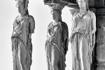 A black and white photograph of the famed caryatids from the Erechtheion on the Acropolis in Athens, Greece