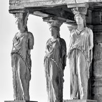 A black and white photograph of the famed caryatids from the Erechtheion on the Acropolis in Athens, Greece