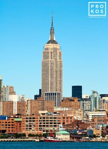 A color cityscape photo of the Empire State Building as seen from Hoboken, New Jersey during the day