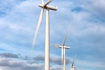 A landscape photo of a row of wind turbines in motion at the Biglow Canyon, Oregon wind farm
