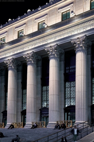 A view of the facade and neoclassical columns of the Farley Building and Moynihan Train Hall in Manhattan, NYC at night by architectural photographer Andrew Prokos. Framed fine art prints of this photo are available in wood, metal and acrylic styles.