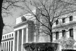 Black and white photography of the United States Federal Reserve building in Washington DC, with a flowing fountain in the foreground. Fine art prints of this photo are available framed in contemporary styles. 
