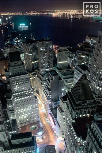 An aerial view of Lower Manhattan, Financial District, the New York Stock Exchange and New York Harbor at night. Framed fine art prints of this photo are available up to 30 inches in height.