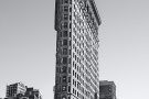 A fine art architectural photo of the Flatiron Building from Broadway in black and white, New York City