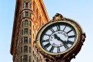 A fine art architectural photo of the New York's Flatiron Building and the Fifth Avenue Clock