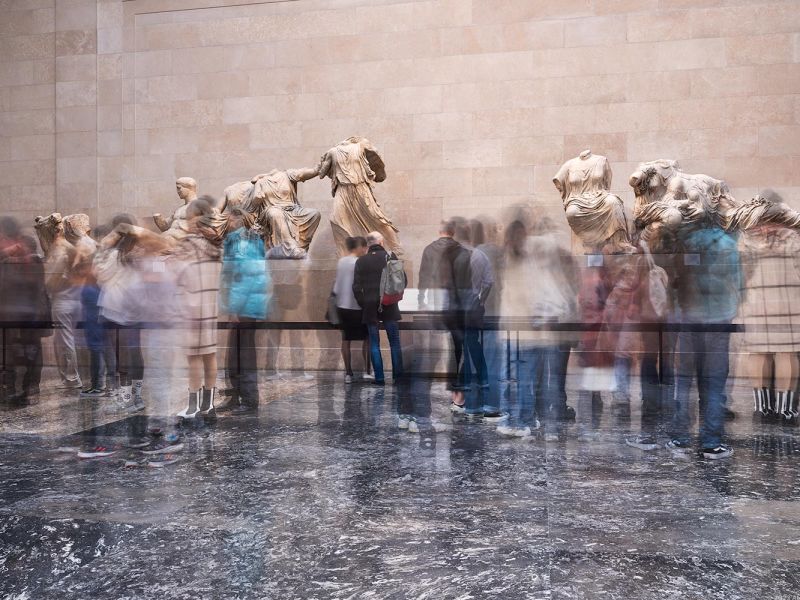 A long-exposure view of visitors viewing the Elgin Marbles at the British Museum, London, United Kingdom. The composition incorporates multiple long-exposure images seamlessly merged into a single pho