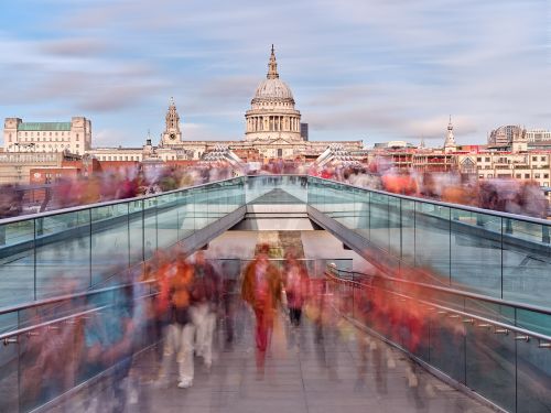 A conceptual photograph capturing the flow of pedestrians in motion crossing London's Millennium Bridge. Limited edition prints of this photo are available up to 80 inches in width.