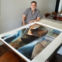 Fine Art Photography - Photographer Andrew Prokos signing a large architectural print from his fine art photo series Gehry's Children