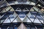 A striking close-up architectural view of 30 St. Mary Axe (aka the Gherkin) building at night, London, United Kingdom