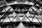 A striking black and white close-up view of 30 St. Mary Axe (aka the Gherkin) building at night, London, United Kingdom