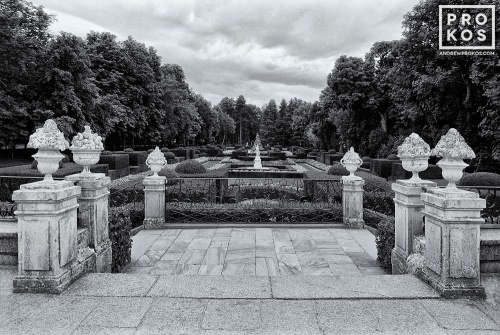 A black and white landscape photo of the balcony overlooking the gardens of the Royal Palace at La Granja de San Ildefonso, Spain. Framed fine art prints of this photo are available in various sizes.