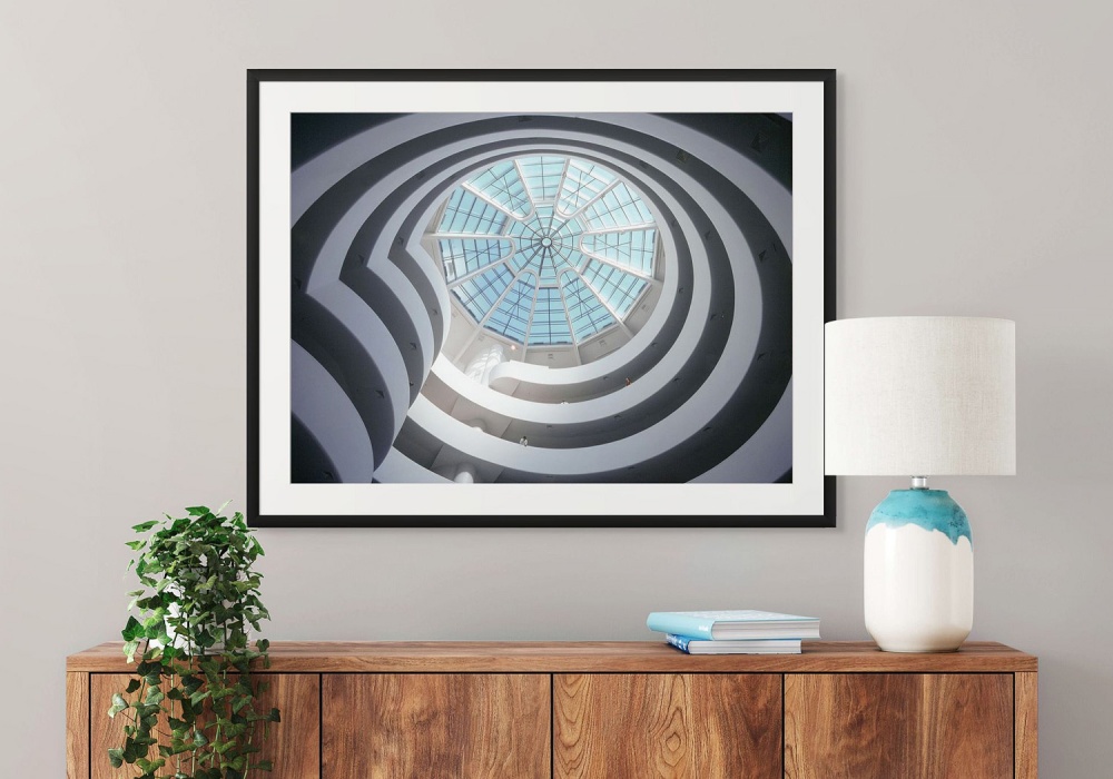 A framed architectural photography print in color of the interior of the Guggenheim Museum in New York by photographer Andrew Prokos
