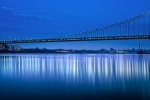 A panoramic photo of the entire span of the George Washington Bridge at night, New York City