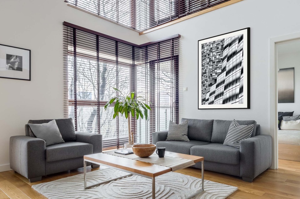 A black and white framed photo of architecture near the High Line in NYC seen in a luxury loft interior. High-definition fine art prints of this photo are available up to 72 inches in height.
