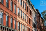 An architectural photo of a row of tenement building facades along Washington Street in Hoboken, New Jersey