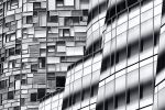 A black and white view of the contemporary facades of the IAC Building and 100 11th Avenue by architects Frank Gehry and Jean Nouvel, in West Chelsea, Manhattan, New York City