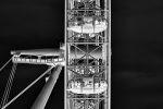 A close-up view of the London Eye Ferris wheel presented as a negative image in black and white from Andrew's photography series 'Inverted'. The wheel structure and pods are captured in detail, showing the visitors riding in each pod. Limited edition fine art prints are available up to 80 inches