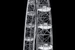 A black and white fine art photograph of the London Eye Ferris wheel from Andrew's award-winning conceptual photography series 'Inverted'. The upper portion of the wheel and pods are captured in detail, showing the visitors riding in each pod.