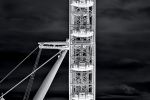 A vertical view of the London Eye Ferris wheel and Thames River is presented as a negative image in black and white in Andrew's photography series 'Inverted'. Large-scale limited edition fine art prints of this photo are available up to 96 inches in height.
