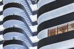 The facade of a modernist building and spiral staircase from Andrew's conceptual photography series "Inverted"
