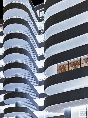 The facade of a modernist building and spiral staircase from Andrew's conceptual photography series "Inverted"