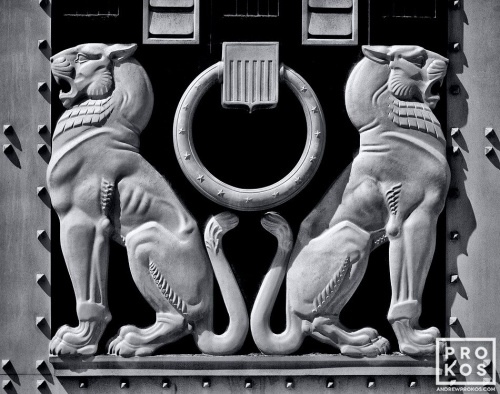 A black and white architectural detail photo of two lions from the doors of the US Justice Department in Washington DC