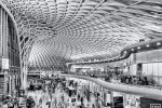 A black and white photograph of the interior of King's Cross Station in London, United Kingdom at rush hour. Limited edition fine art prints of this photo are available up to 80 inches in width and framed in various wood, metal, and acrylic styles. 