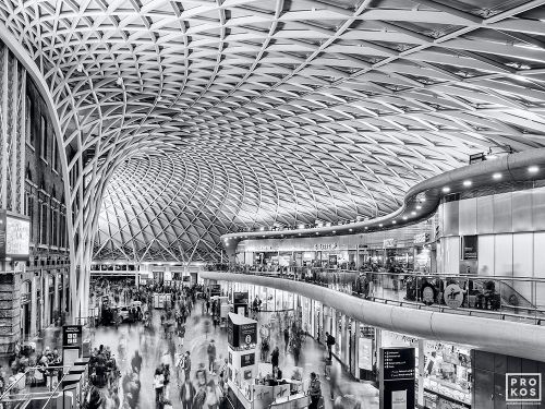 A black and white photograph of the interior of King's Cross Station in London, United Kingdom at rush hour. Limited edition fine art prints of this photo are available up to 80 inches in width and framed in various wood, metal, and acrylic styles. 