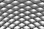 An architectural detail from the undulating glass and steel roof which covers Kogod Courtyard, located between the National Portrait Gallery and the Smithsonian Museum of American Art, Washington DC.
