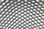An architectural detail from the undulating glass and steel roof which covers Kogod Courtyard, located between the National Portrait Gallery and the Smithsonian Museum of American Art, Washington DC.