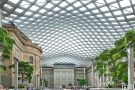 An architectural interior photo of Kogod Courtyard, with its undulating glass and steel canopy in the National Portrait Gallery, Washington DC